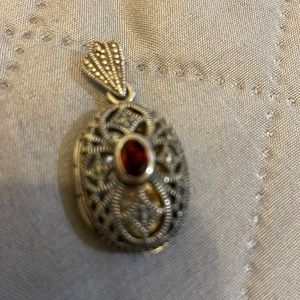 Locket with garnet.